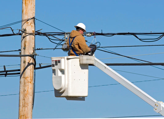 Bucket truck in use fixing power lines. Available at seller7vip.com
