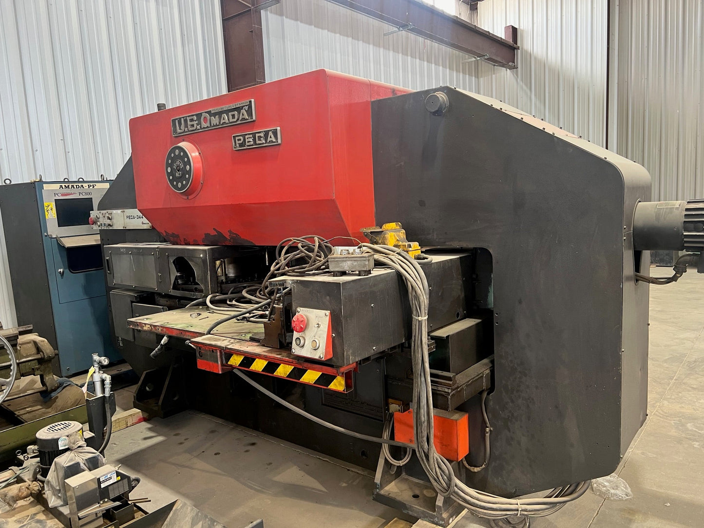 A Pega 344 Hole Puncher, featuring a compact design, precision punching capabilities, and intuitive controls for efficient hole punching tasks in various materials.