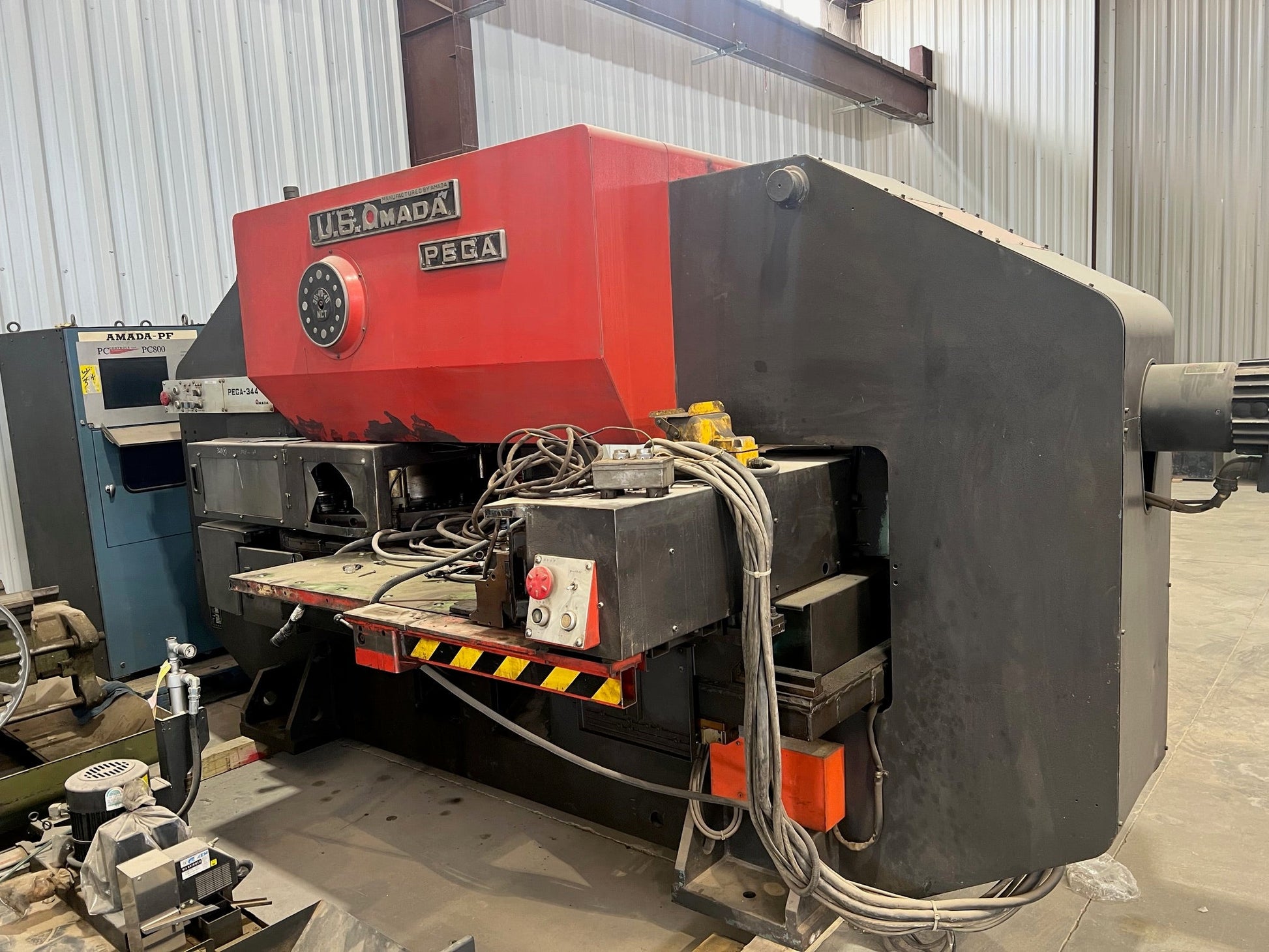 A Pega 344 Hole Puncher, featuring a compact design, precision punching capabilities, and intuitive controls for efficient hole punching tasks in various materials.