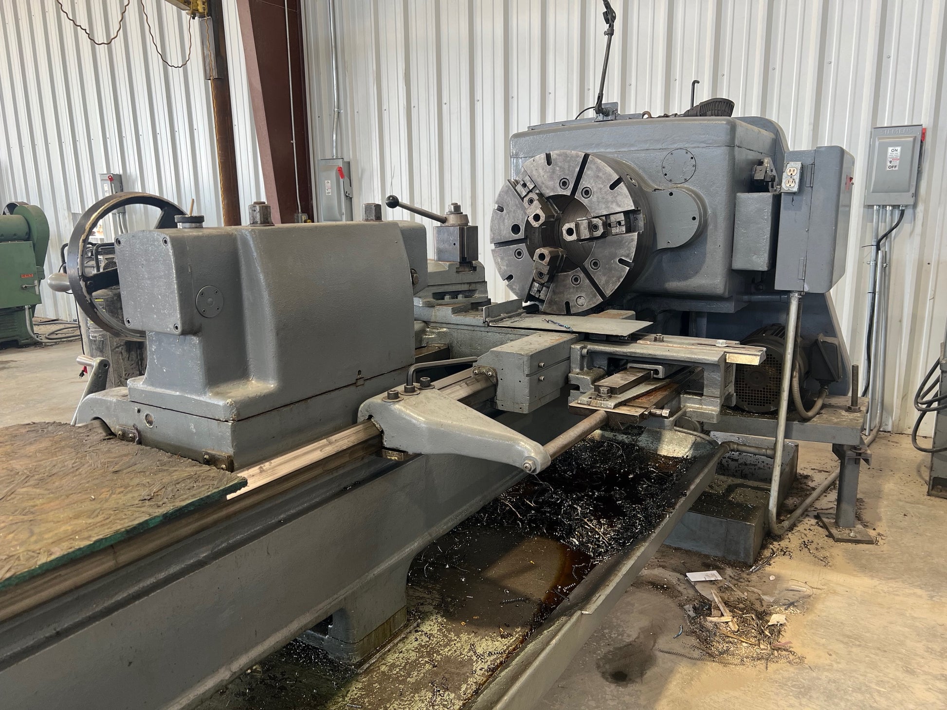 An industrial-sized Lodge and Shipley Lathe, a heavy-duty machinery with metallic components, gears, and control panels, ready for manufacturing processes.