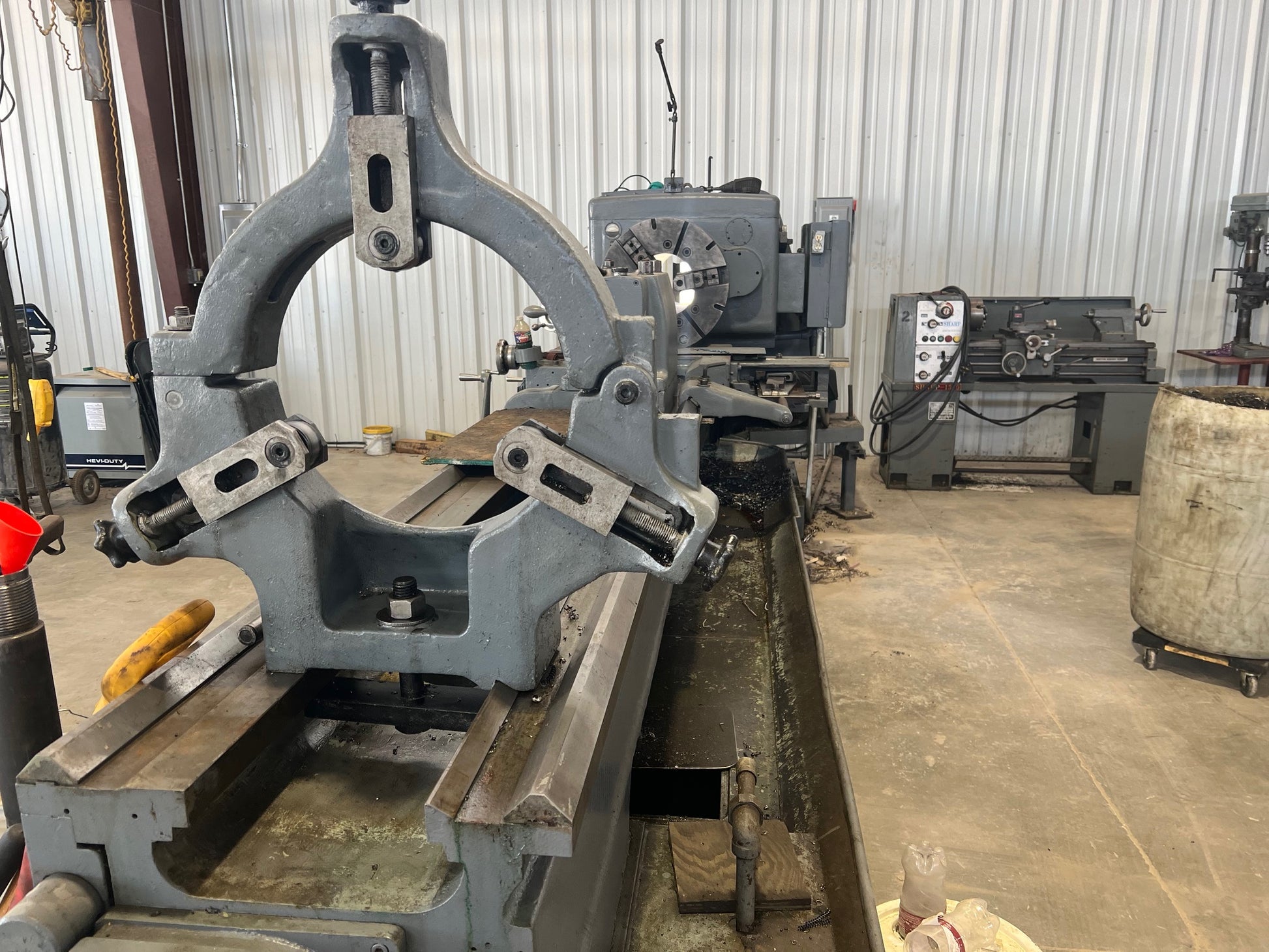 An industrial-sized Lodge and Shipley Lathe, a heavy-duty machinery with metallic components, gears, and control panels, ready for manufacturing processes.